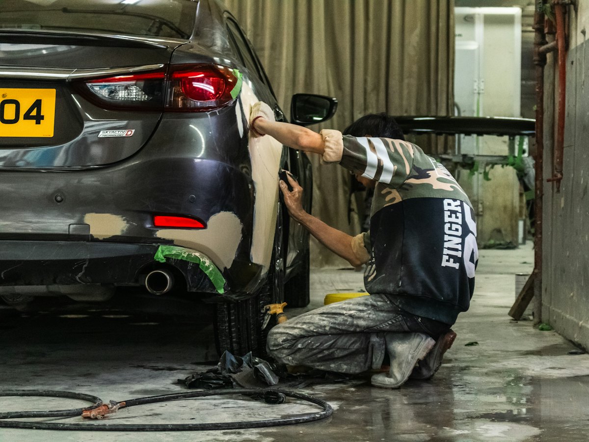 Technician finishing a rear bumper repair